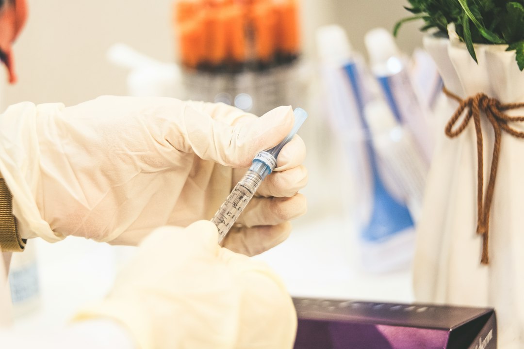 A Close-up Of A Hand Holding A Syringe