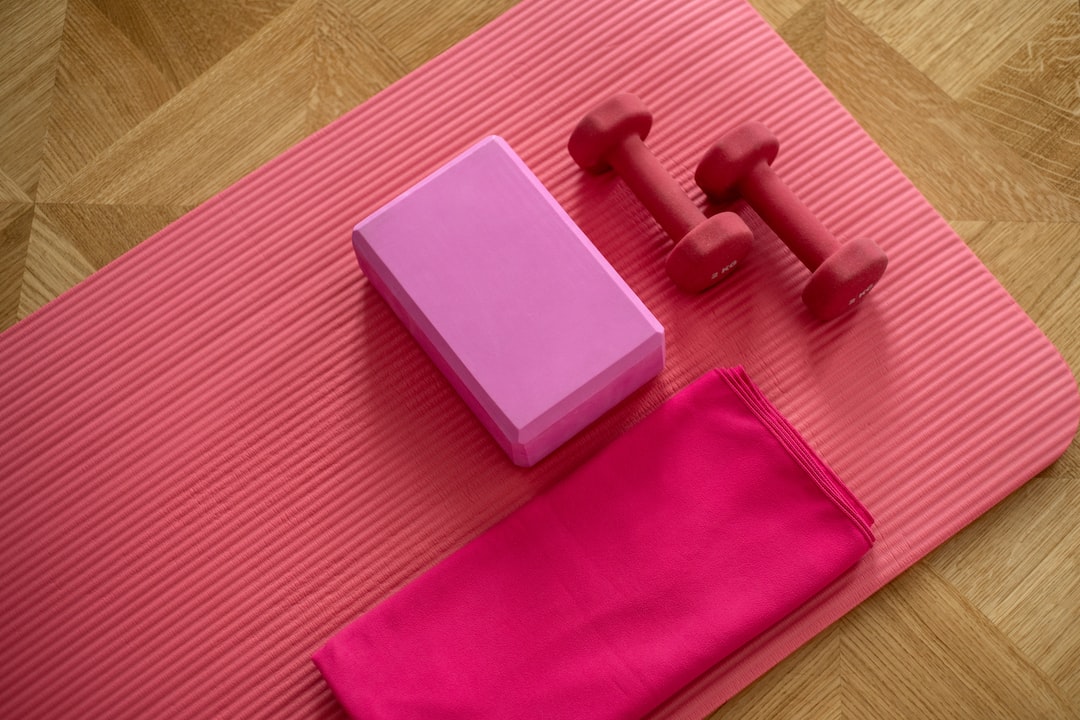 A Yoga Mat And Dumbbells Kept On A Floor